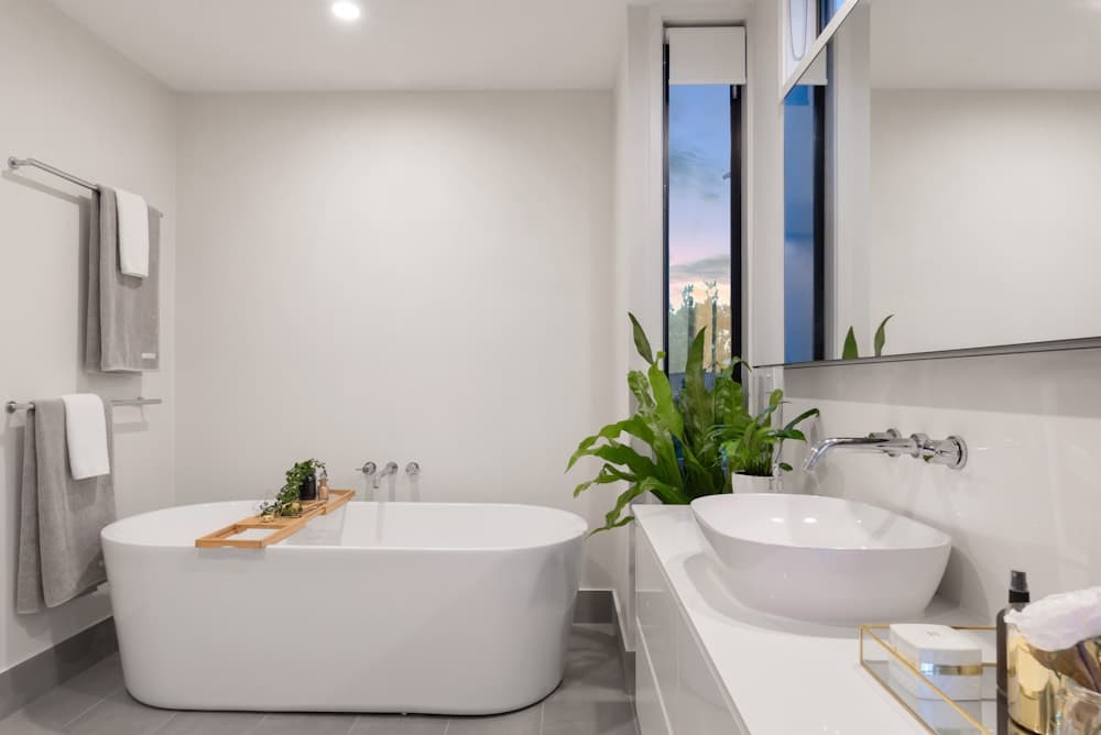 Bathroom inspiration with a freestanding tub beside a floating vanity
